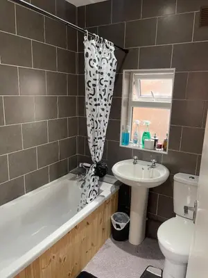 a bathroom with a tub and a sink and a toilet at New Stylish Large 1-Bed Apartment - Close to Old Trafford & More in Moffat