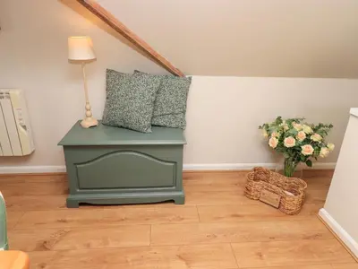 a table with two pillows on top of it in a room at Corner Cottage in Penrith