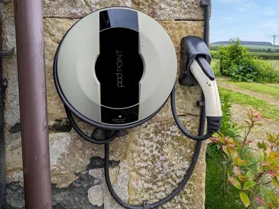 a black and white hair dryer hanging on a wall at Torr Cottage in Dalrymple