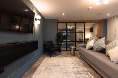 a living room with a couch and a chair at Luxury Georgian Aparthotel by Hauss Ayr - 5mins to Beach, Town Centre! in Ayr