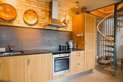 a kitchen with a sink and a stove top oven at Lighthouse Studio Apartment in Portpatrick