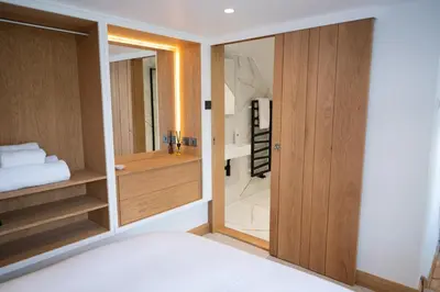 a bathroom with a glass door leading to a shower at Tucked Away in Keswick