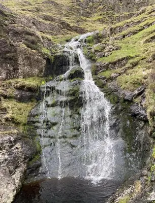 a waterfall on the side of a mountain at Zions Retreat in Plumbland