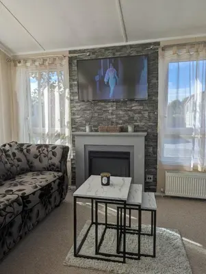 a living room with a couch and a fireplace at Zions Retreat in Plumbland