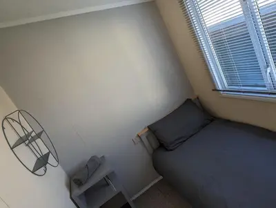 a small bedroom with a bed and a window at Zions Retreat in Plumbland