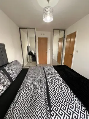 a bedroom with a bed with a black and white comforter at Z&Z Villa in Moffat
