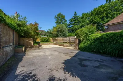 a driveway in front of a house with a fence at Beautiful 3 bedroom cottage close to Goodwood ! in Moffat