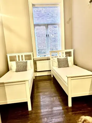 two white beds in a room with a window at High living @ Ferguson Court in Carlisle