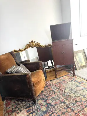 a living room with two chairs and a mirror at High living @ Ferguson Court in Carlisle