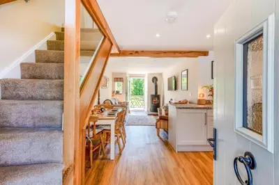 a kitchen and living room with a staircase and a dining room at 2 Bed in Caldbeck oc-a32049 in Caldbeck
