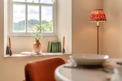a table with a lamp and a window in a room at 2 Bed in Chapel Stile oc-u32104 in Chapel Stile