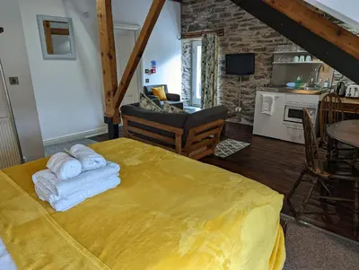 a bedroom with a bed with towels on it at Lake View Country House and Self-catering Apartments in Grasmere