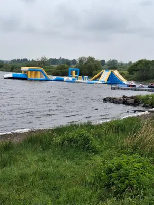 a row of inflatable boats in the water at The Coo Shed 94 in Newton Stewart