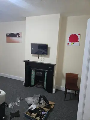 a living room with a fireplace and a tv at Carlton road in Moffat