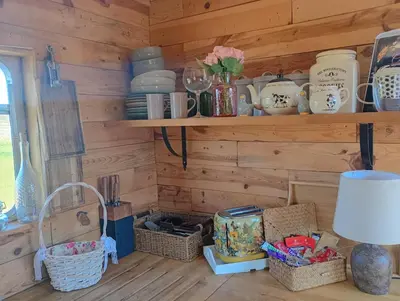 a room with wooden walls with shelves and baskets at The Box in Moffat