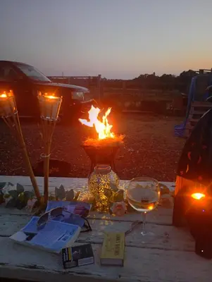 a table with a fire in a vase with lights at The Box in Moffat