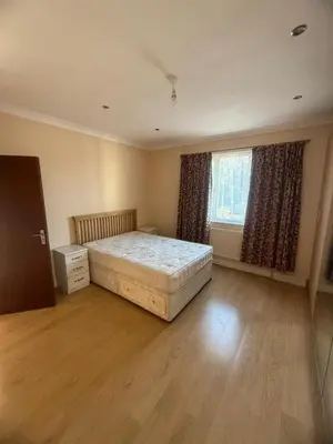 a bedroom with a bed and a dresser and a window at Harrow Inn Rooms in Yarrow