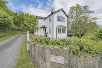a white house on the side of a road at 3 Bed in Ravenglass oc-e32106 in Ravenglass