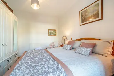 a bedroom with a large bed with pillows at 2 Bed in Moffat oc-a32121 in Moffat