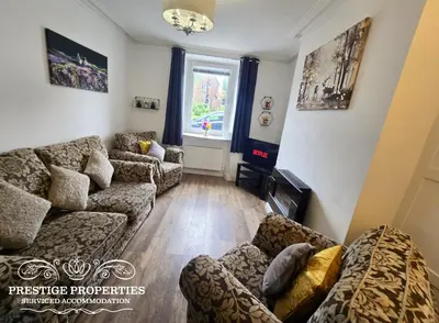 a living room with couches and a window at Moon Cottage By Prestige Properties SA in Egremont