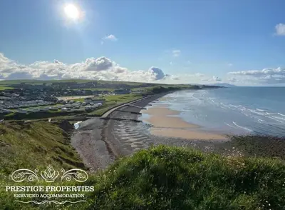 an aerial view of a beach and the ocean at Moon Cottage By Prestige Properties SA in Egremont