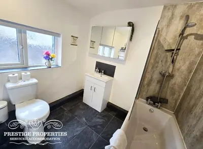 a bathroom with a shower and a toilet and a sink at Moon Cottage By Prestige Properties SA in Egremont
