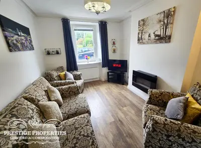 a living room with two couches and a fireplace at Moon Cottage By Prestige Properties SA in Egremont
