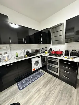 a kitchen with a sink and a dishwasher in it at Cosy Double Bedroom in Little Venice, Maide Vale in Moffat