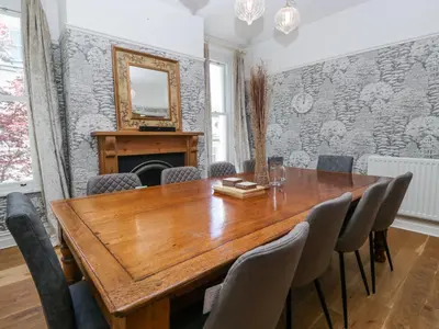 a dining room with a wooden table and chairs at Sunnycroft in Keswick