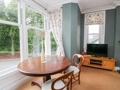 a dining room with a table and a window at Sunnycroft in Keswick