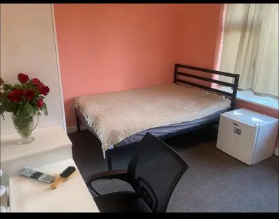 a small room with a bed and a desk and chairs at Coven in Moffat