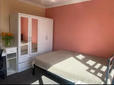 a bedroom with a bed and a dresser and a mirror at Coven in Moffat