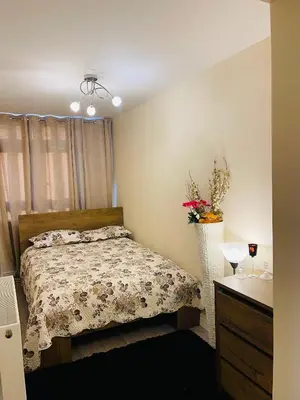 a bedroom with a bed and a vase of flowers at Bow Church in Moffat