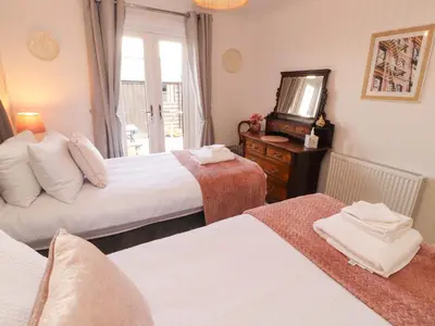 a hotel room with two beds and a television at The Paddock in Kirkcowan