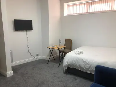 a bedroom with a bed and a table with a television at Marina Regency in Moffat