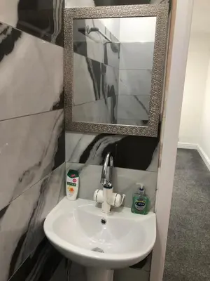 a white sink in a bathroom with a mirror at Marina Regency in Moffat