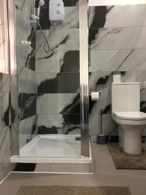 a bathroom with a shower and a toilet at Marina Regency in Moffat