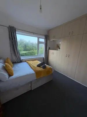 a bedroom with a bed with a large window at Modern 3BR House Near Manchester-Parking Included in Moffat