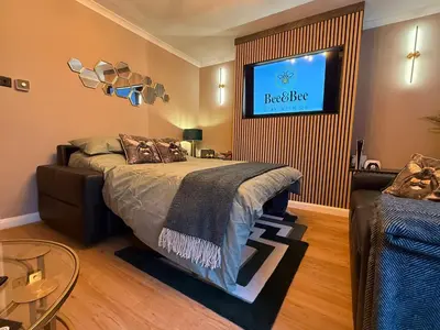 a bedroom with a bed and a tv on the wall at Modern House Maryport Sleeps 6 in Maryport