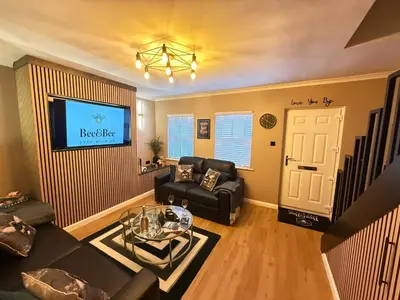 a living room with a couch and a tv at Modern House Maryport Sleeps 6 in Maryport