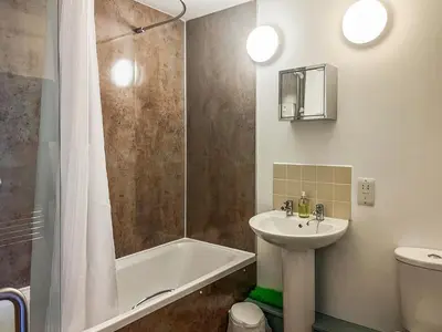 a bathroom with a sink and a tub and a toilet at Ninians Landing in Kirkcudbright