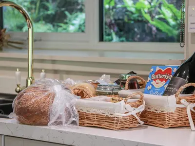 a kitchen counter with baskets of food and bread at Nithbank Cottage in Thornhill