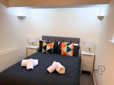 a bedroom with a large bed with two pillows at Old Corner Barn Lake District Escape by PolkaStays in Penrith