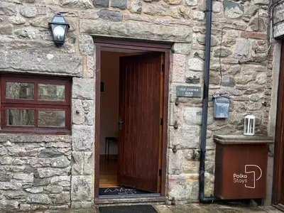 a wooden door of a stone building at Old Corner Barn Lake District Escape by PolkaStays in Penrith