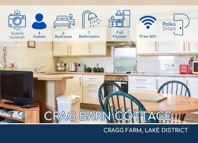 a kitchen with a table and chairs and a tv at Crag Barn Cottage Lake District by PolkaStays in Penrith
