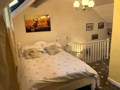 a bedroom with a white bed in a room at 2 Bedroom & 2Bathrooms in Lancaster in Moffat