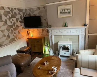 a living room with a couch and a fireplace at 2 Bedroom & 2Bathrooms in Lancaster in Moffat