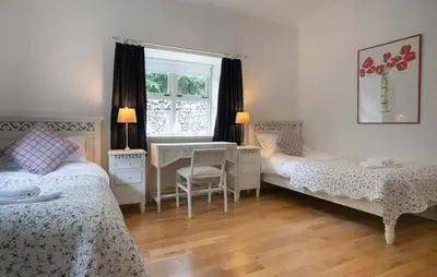 a bedroom with two beds and a window at Mid Lodge, Penninghame Estate in Challoch
