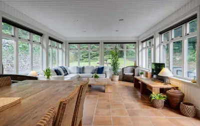 a large living room with a table and a couch at Mid Lodge, Penninghame Estate in Challoch