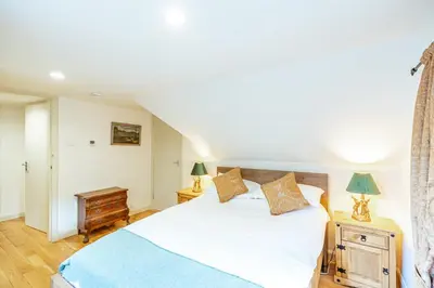 a bedroom with a white bed and two lamps at Penninghame Estate - West Lodge in Challoch